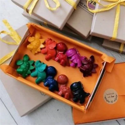 one open box of soy wax dinosaurs with gift wrapped boxes surrounding