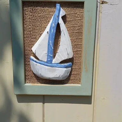 Handcarved boat on a hessian sage frame 1