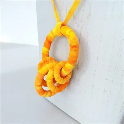 Yellow fabric pendant necklace detail