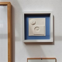 3D ceramic wall art '2 in, 2 out' in room setting