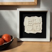 3D ceramic wall art 'More or Less' in room setting