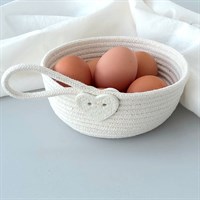 Cotton rope bowl with porcelain button trim filled with eggs