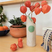 Harlequin ceramic vase with green glaze in room setting