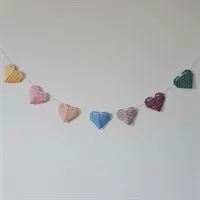 Origami heart garland hanging on the wall