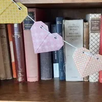 Origami heart garland on bookshelf