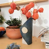 Single buttoned blue ceramic vase